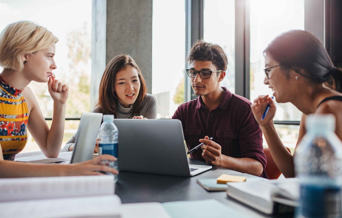 International students using their laptop to search for a student visa checklist online