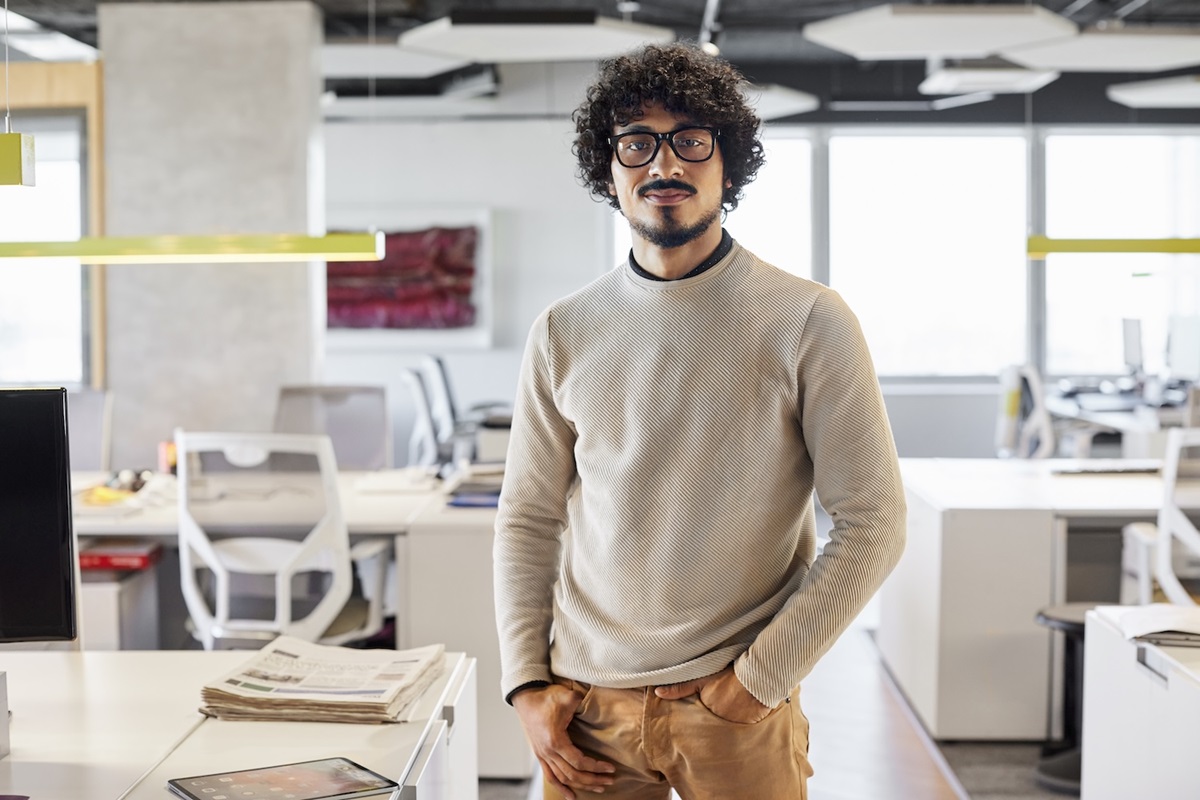 Man with glasses feeling happy after making easy, fast health insurance claim on 408 visa