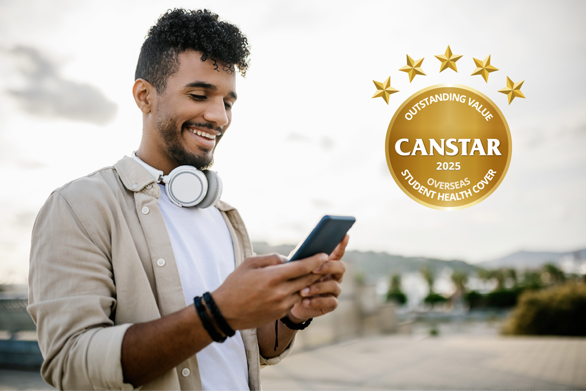 A man checking his phone about Canstar award