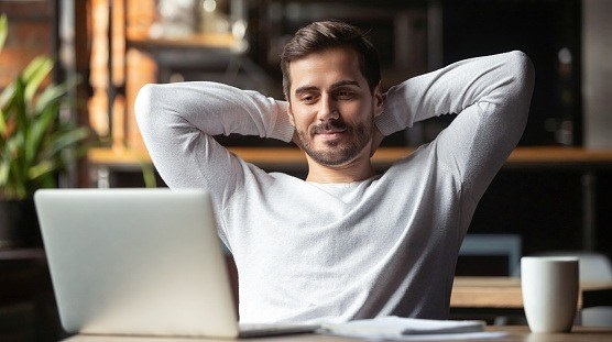 Man looking at his screen looking content